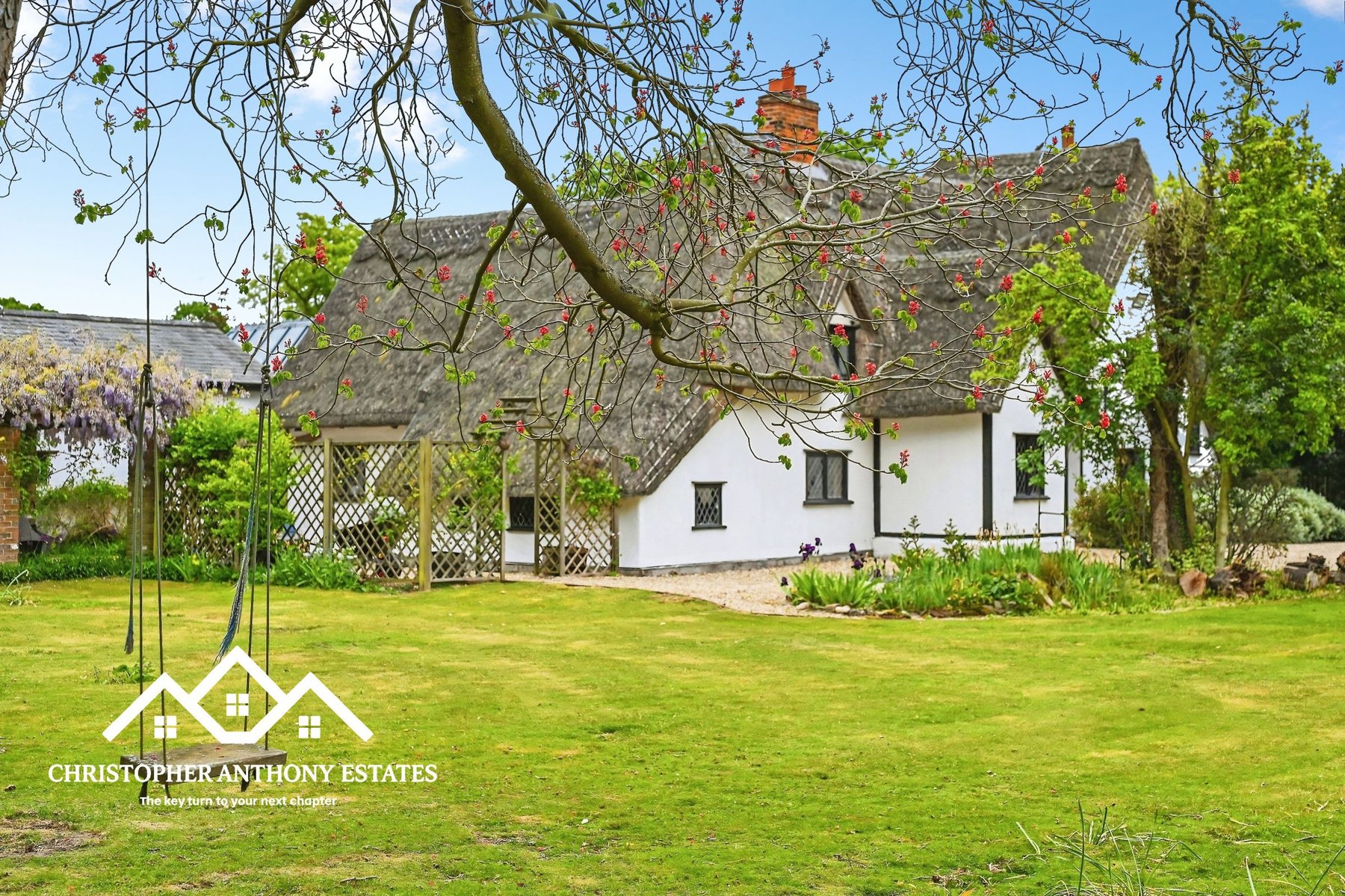 Aerial view of Hospytts, a Grade II Listed thatched house at Great Horkesley